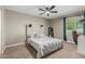Comfortable bedroom features a ceiling fan and natural light from the window at 3061 W Betty Elyse Ln, Phoenix, AZ 85053