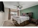 Cozy bedroom with a plush bed, ceiling fan, and large window offering a comfortable and inviting space at 3061 W Betty Elyse Ln, Phoenix, AZ 85053