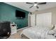 Large bedroom with a TV, ensuite bathroom, closet and stylish bed, offering a serene and private retreat at 3061 W Betty Elyse Ln, Phoenix, AZ 85053