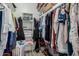 Organized walk-in closet with shelves, hanging racks, and various storage solutions for optimal space utilization at 3061 W Betty Elyse Ln, Phoenix, AZ 85053