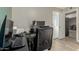 Home office with laminate floors, black desk and chair, ready for productivity at 3061 W Betty Elyse Ln, Phoenix, AZ 85053