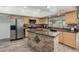 Kitchen featuring stainless steel appliances, granite countertops, and a kitchen island at 3061 W Betty Elyse Ln, Phoenix, AZ 85053