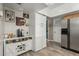 Coffee bar area with custom cabinetry, stainless steel refrigerator, and modern decor at 3061 W Betty Elyse Ln, Phoenix, AZ 85053