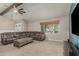 Cozy living room featuring a comfortable sectional sofa, coffee table, and window with natural light at 3061 W Betty Elyse Ln, Phoenix, AZ 85053