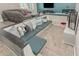 Spacious living room highlighting a custom seating area, a large TV, and plush seating options at 3061 W Betty Elyse Ln, Phoenix, AZ 85053