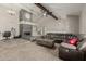 Comfortable living room featuring a fireplace, high ceiling, ceiling fan, and spacious sectional sofa at 3061 W Betty Elyse Ln, Phoenix, AZ 85053