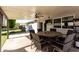 Covered patio includes a ceiling fan, TV, BBQ, and outdoor dining set at 3061 W Betty Elyse Ln, Phoenix, AZ 85053