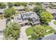 A beautiful aerial view of a landscaped home featuring a long driveway, lush lawn, and numerous solar panels at 3062 E Cullumber St, Gilbert, AZ 85234