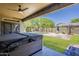 Covered patio overlooks lush backyard with pool, creating a perfect outdoor living space at 3062 E Cullumber St, Gilbert, AZ 85234