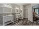 Bright bathroom with dual vanities, decorative tile backsplash, and wood look flooring for an updated feel at 3062 E Cullumber St, Gilbert, AZ 85234