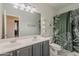 A bathroom with a double vanity and stylish leaf-patterned shower curtain, blending comfort with modern design at 3062 E Cullumber St, Gilbert, AZ 85234