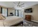 Comfortable bedroom featuring a ceiling fan, wood floors, and a glass door leading to the outdoors at 3062 E Cullumber St, Gilbert, AZ 85234