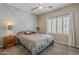 This is a bedroom with a gray bed, white shutters, and geometric design on the wall at 3062 E Cullumber St, Gilbert, AZ 85234