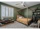 This is a bedroom with green walls, a bed with a wooden frame, and shutters on the windows at 3062 E Cullumber St, Gilbert, AZ 85234