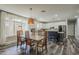 Bright dining space with a wood table set near a window and modern, white kitchen at 3062 E Cullumber St, Gilbert, AZ 85234