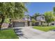 Large two-story home with a three-car garage, lush lawn, and mature trees at 3062 E Cullumber St, Gilbert, AZ 85234