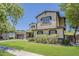 Exterior view of a two-story home with lush landscaping, lawn, and a three-car garage at 3062 E Cullumber St, Gilbert, AZ 85234