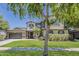 Charming two-story home featuring a lush green lawn, mature trees, and a well-maintained exterior at 3062 E Cullumber St, Gilbert, AZ 85234