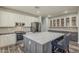 Spacious kitchen featuring a large center island, white cabinets, stainless steel appliances, and stylish countertops at 3062 E Cullumber St, Gilbert, AZ 85234