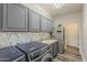 Well-equipped laundry room with modern appliances, cabinetry, and a sink for convenience at 3062 E Cullumber St, Gilbert, AZ 85234