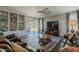 Cozy living room with a ceiling fan, built-in shelves, and comfortable leather furniture at 3062 E Cullumber St, Gilbert, AZ 85234