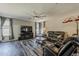 Spacious living room with a ceiling fan, leather sofa, and entertainment center at 3062 E Cullumber St, Gilbert, AZ 85234