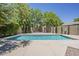 Refreshing backyard pool is surrounded by mature landscaping for a private swimming experience at 3062 E Cullumber St, Gilbert, AZ 85234