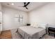 Comfortable bedroom with wood floors and a ceiling fan, perfect for relaxation at 3150 E Beardsley Rd # 1081, Phoenix, AZ 85050