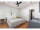 Comfortable bedroom with wood floors and a ceiling fan, bathed in natural light at 3150 E Beardsley Rd # 1081, Phoenix, AZ 85050