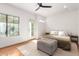 Light and airy bedroom with wood floors, natural light, and a comfy bed at 3150 E Beardsley Rd # 1081, Phoenix, AZ 85050
