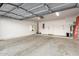 Spacious garage with epoxy floor, shelving unit, door to the house and water heater at 3150 E Beardsley Rd # 1081, Phoenix, AZ 85050