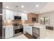 Modern kitchen featuring white cabinetry, stainless steel appliances, and a spacious quartz countertop at 3150 E Beardsley Rd # 1081, Phoenix, AZ 85050