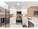 Modern kitchen featuring white cabinetry, stainless steel appliances, and a spacious quartz countertop at 3150 E Beardsley Rd # 1081, Phoenix, AZ 85050