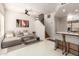 Open-concept living room with modern decor, a staircase, and a partial kitchen view at 3150 E Beardsley Rd # 1081, Phoenix, AZ 85050