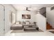 Bright living room with a large couch, modern art, and access to a staircase at 3150 E Beardsley Rd # 1081, Phoenix, AZ 85050