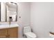 Bright powder room featuring a wood vanity, modern rectangle mirror, and neutral wall color at 3150 E Beardsley Rd # 1081, Phoenix, AZ 85050