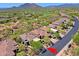 Aerial view of the community showcasing a golf course and distant mountain views at 32710 N 71St St, Scottsdale, AZ 85266