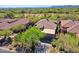 Aerial view of home featuring mature desert landscaping, tile roof, and expansive community at 32710 N 71St St, Scottsdale, AZ 85266