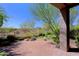 Paver patio overlooking a private backyard with mature trees and desert landscaping at 32710 N 71St St, Scottsdale, AZ 85266