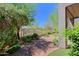 Beautiful backyard featuring a brick patio, lush landscaping, mature trees and desert views at 32710 N 71St St, Scottsdale, AZ 85266