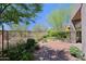 Paver patio overlooking a fenced private backyard with lush landscaping and desert scenery at 32710 N 71St St, Scottsdale, AZ 85266