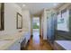 Hallway view of a bathroom featuring double sinks, glass shower and a bathtub at 32710 N 71St St, Scottsdale, AZ 85266