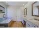 Bathroom featuring double sinks and a glass enclosed tub with shower at 32710 N 71St St, Scottsdale, AZ 85266