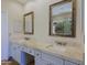 Bathroom featuring double sinks with stone counters and rustic framed mirrors at 32710 N 71St St, Scottsdale, AZ 85266