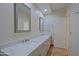 Modern bathroom featuring a double vanity with marble countertops and framed mirrors at 32710 N 71St St, Scottsdale, AZ 85266