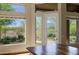 Bright dining area with large windows offering views of the desert landscaping, granite countertops, and access to patio at 32710 N 71St St, Scottsdale, AZ 85266