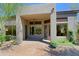 Exterior view showing a covered entrance and views into the home's living spaces at 32710 N 71St St, Scottsdale, AZ 85266
