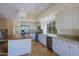 Bright kitchen with white cabinets, stainless appliances, granite countertops and large butcher block island at 32710 N 71St St, Scottsdale, AZ 85266