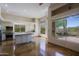 Open kitchen and dining area with stainless appliances, island and views to desert landscaping at 32710 N 71St St, Scottsdale, AZ 85266