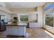 A spacious kitchen featuring stainless steel appliances, a center island, and lots of natural light at 32710 N 71St St, Scottsdale, AZ 85266